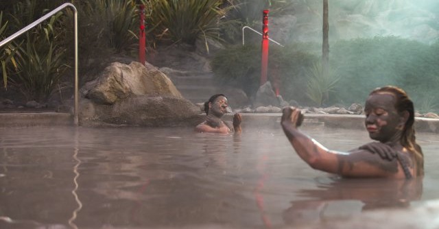 Two people in mud spa at Hells Gate Rotorua